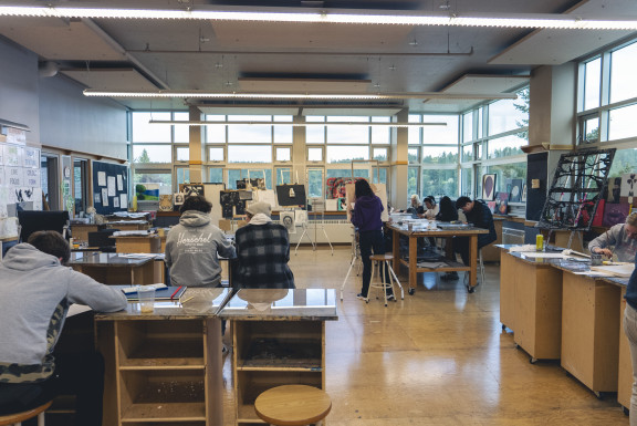 A class of students painting in the art studio