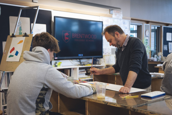 A teacher explaining a technique in art class