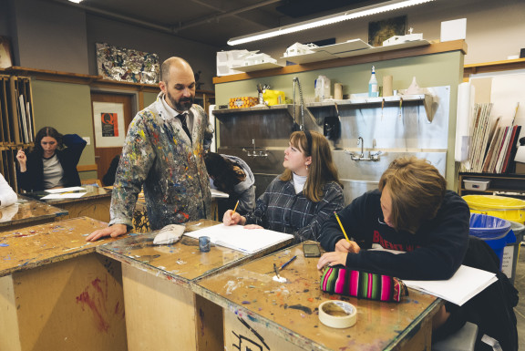 A student and teacher discussing art in the studio
