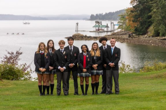Student Leaders with ocean and kayaks behind them