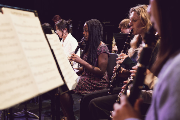 The wind ensemble playing on stage