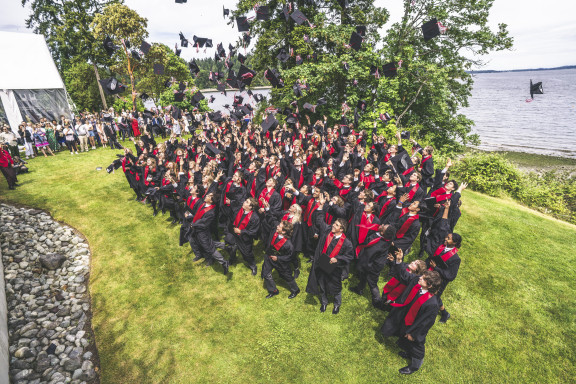 The graduating class throwing their caps in the air