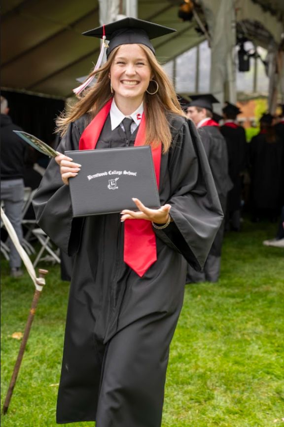 University preparatory graduate smiling with her certificate