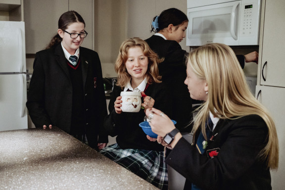 Students having breakfast in the house kitchen