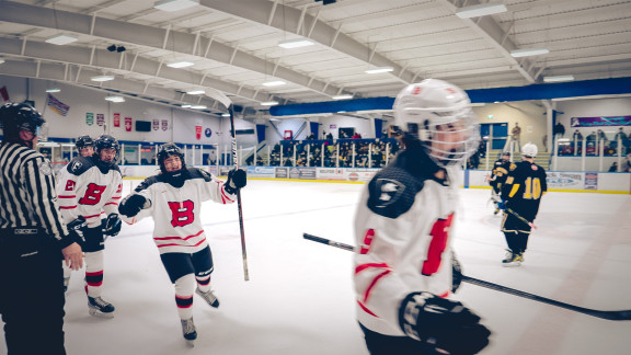 Private school hockey players celebrating a goal