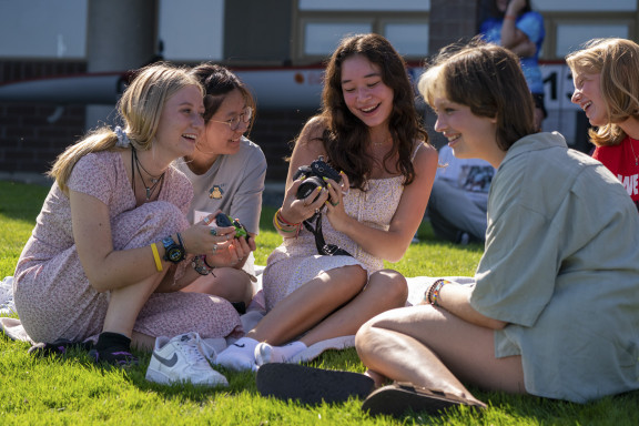 Students looking at a picture on a camera