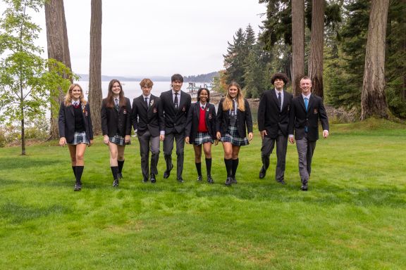 Private school students walking on grass
