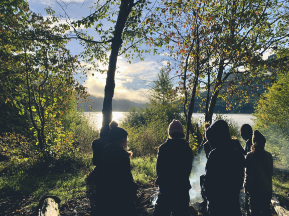 students around a campfire in the evening