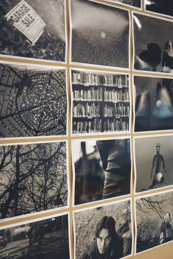 A collage of black and white photos on a wall