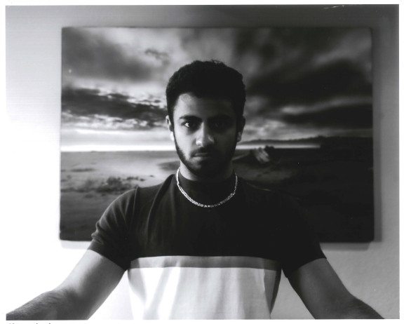 A portrait photo of a student with a beach in the background