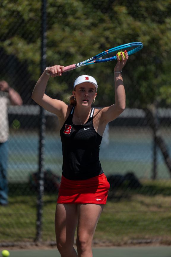 A tennis player preparing to serve