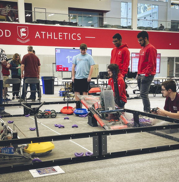 A robotics arena with competitors outside