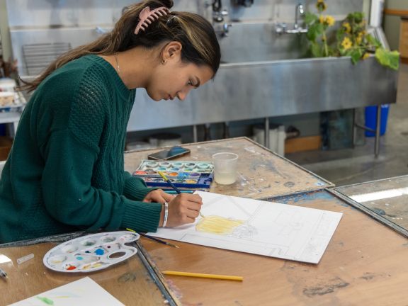 A student working with paintbrush