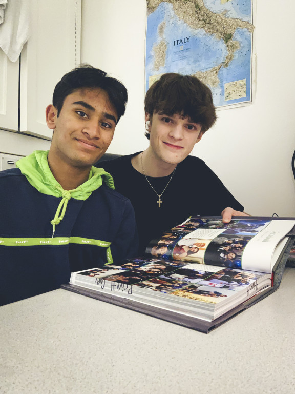 Two students looking at the yearbook