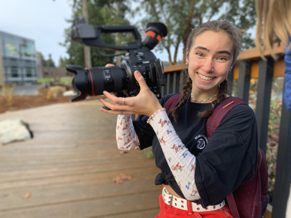 A film student holding a camera