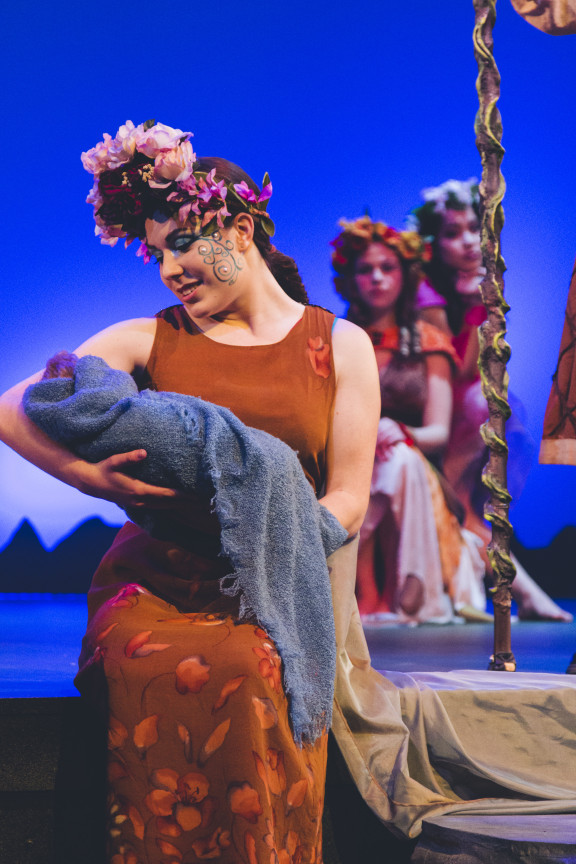 An actor looks at a bundle while performing Shakespeare