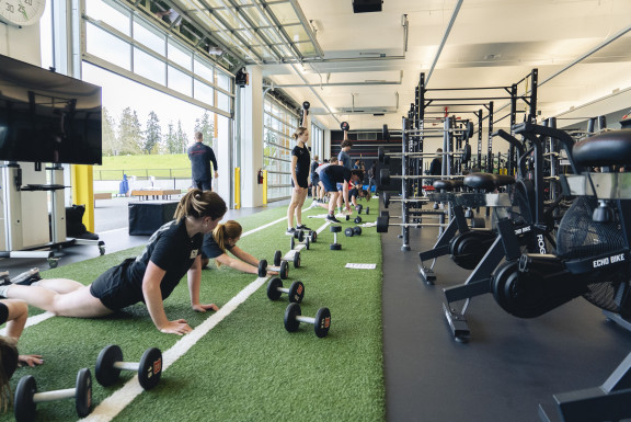 Students lifting weights in the gym