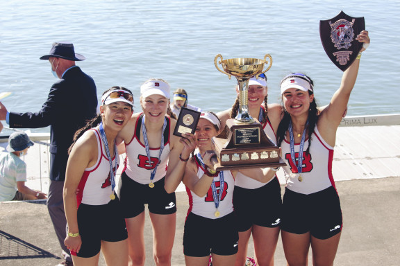 Students holding a trophy and at the national championships