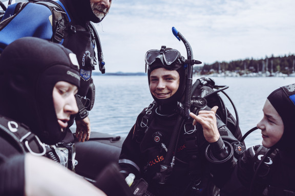 A student smiling before a dive