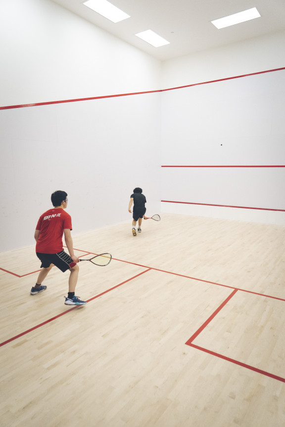 A squash player hitting the ball