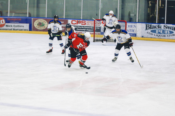 A player carrying the puck on the ice