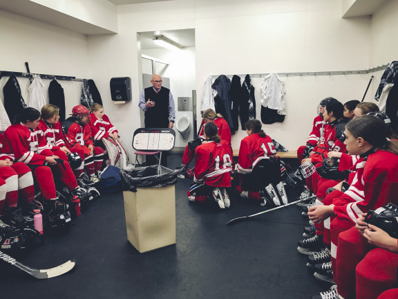 The coach talking to players in the changeroom