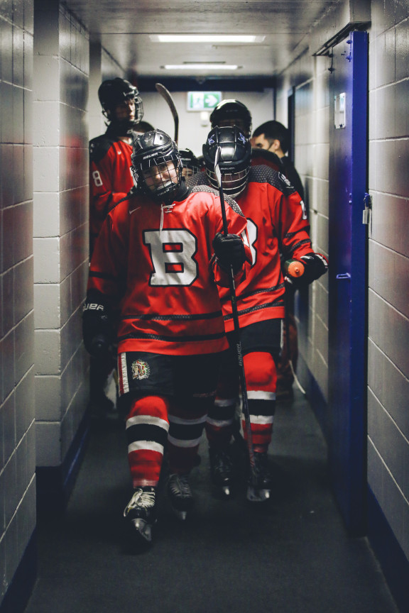 Hockey players walking down the arena hallway