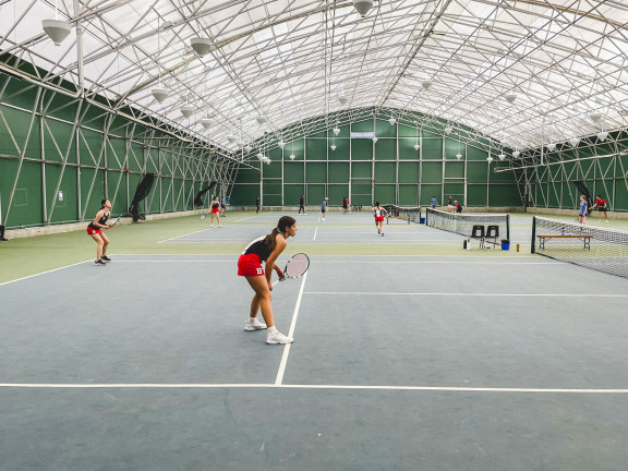 Tennis players practicing indoors