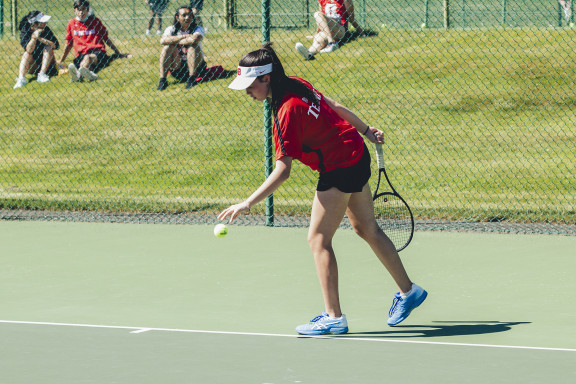 A tennis player preparing to serve