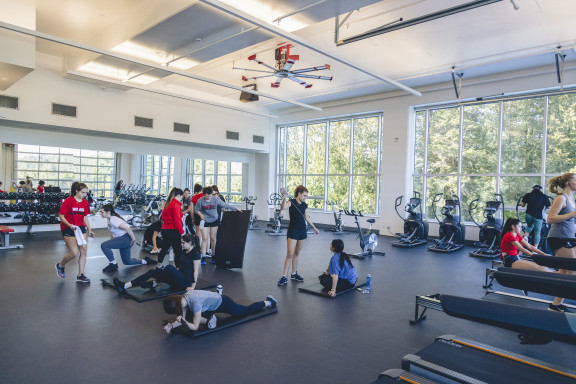 A group of students stretching in the gym