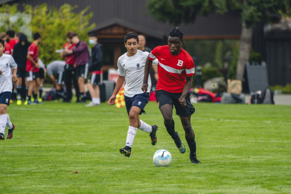 A soccer player dribbling with the ball