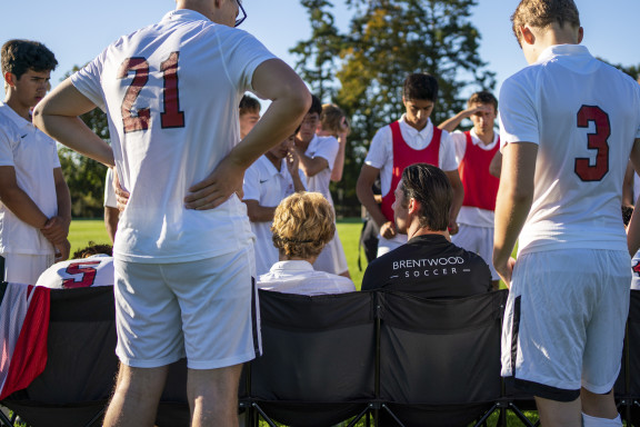 A coach talking to the players at half time