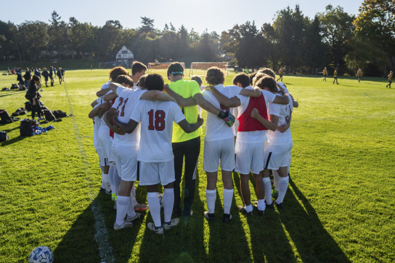 A team huddle of players at the start of a match