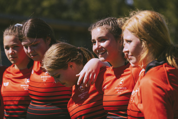 A team smiling after a hard-fought game