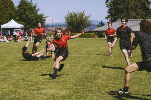 A rugby player about to make a cut move past an opponent