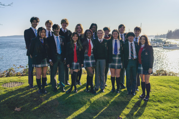 Students in uniform with the ocean in the background