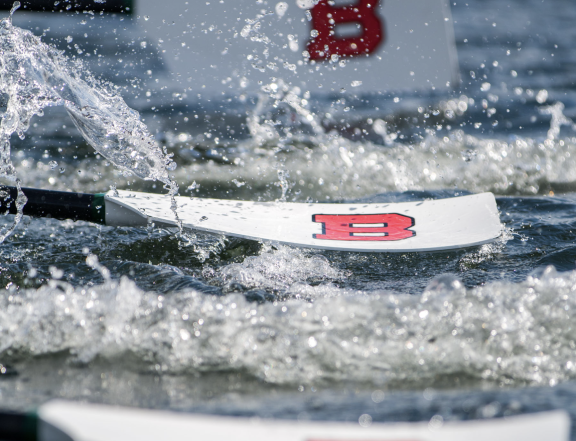 A rowing oar coming out of the water