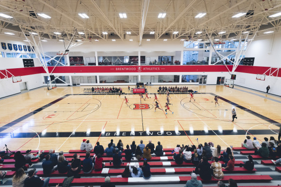 A basketball game taking place in the large Wheaton Gym