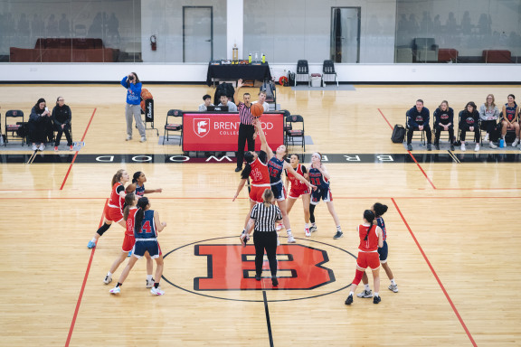 Basketball players jumping for the ball during a tip off