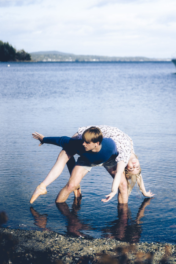 Two dance students posing in the ocean