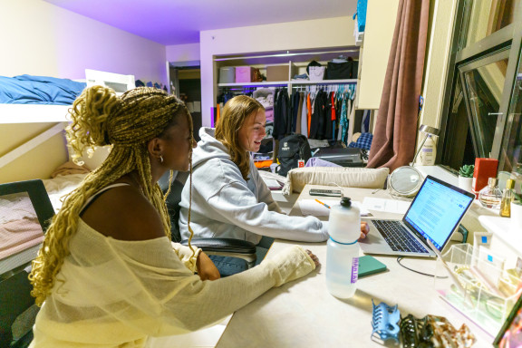 Two students working in their dorm room
