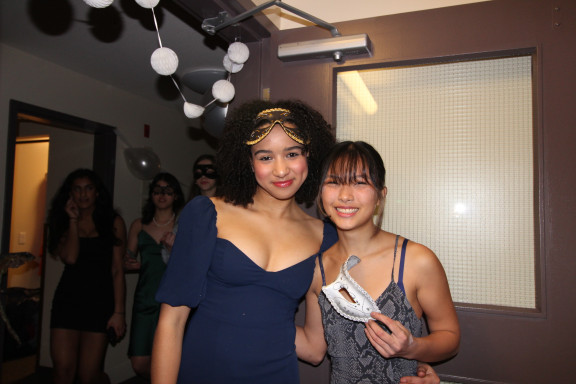 Two student with masks dressed up for an open house