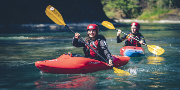 Two kayakers paddling down the Cowichan River