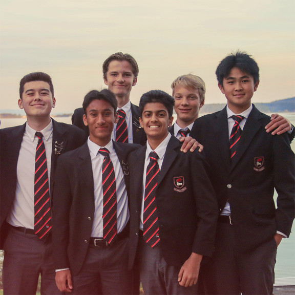 A group of boys in uniform at a formal dinner