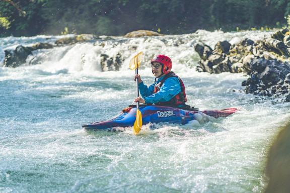 A student enjoying river kayaking