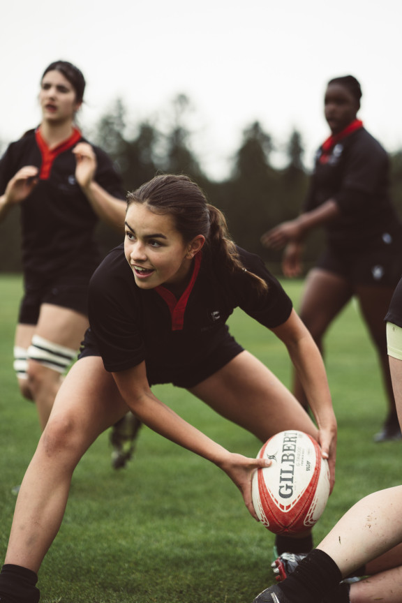 A scrum half preparing to pass the ball