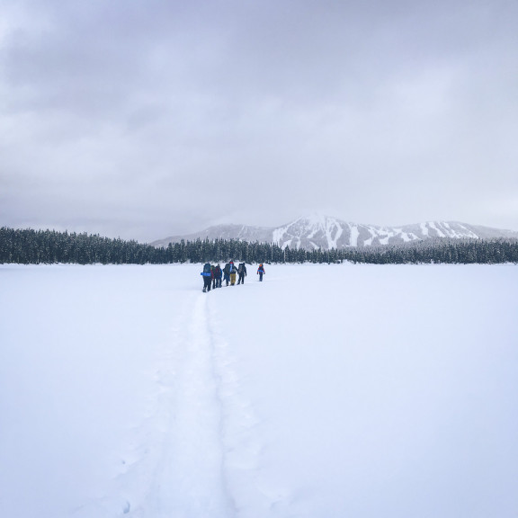 Students crossing a field covered in snow