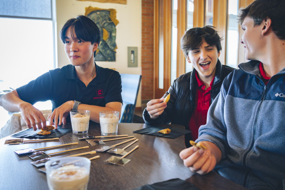 Three boys enjoying the food in the Student Centre