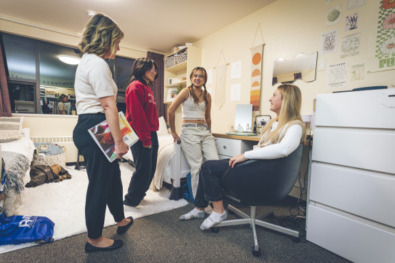 Boarding students speaking with a house parent