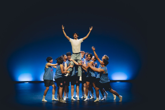 A student being lifted in the air during an Airband performance
